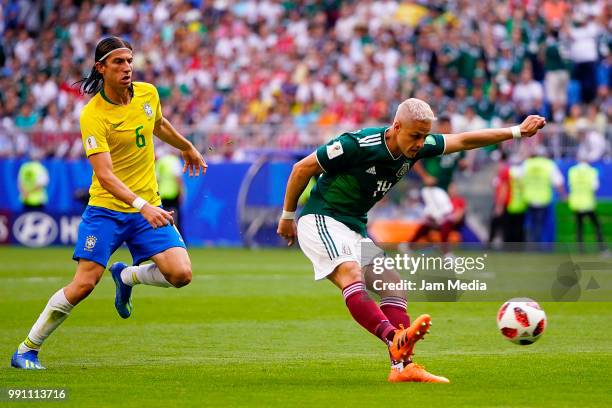 Javier Hernández of Mexico takes a shot as Filipe Luis of Brazil defends during the 2018 FIFA World Cup Russia Round of 16 match between Brazil and...