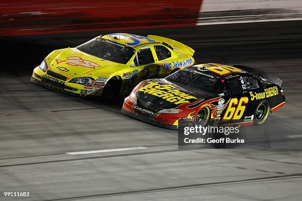Steve Wallace, driver of the 5-Hour Energy Toyota, races against Tony Raines, driver of the Long John Silver's Chevrolet during the NASCAR Nationwide...