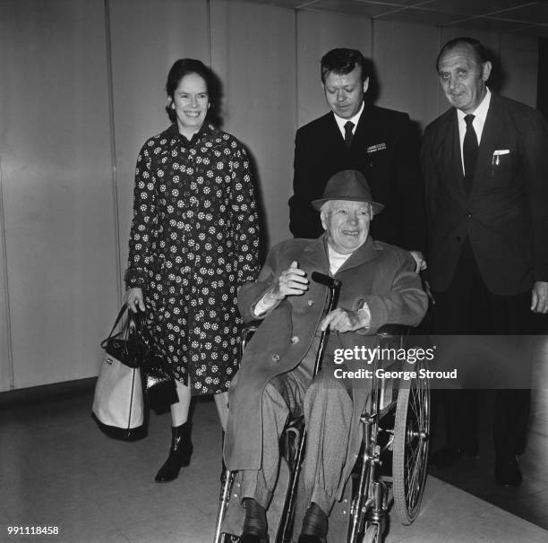 English comic actor, filmmaker, and composer Charlie Chaplin and his wife, Oona O'Neill , arrive at Heathrow Airport, London, UK, 22nd May 1973.