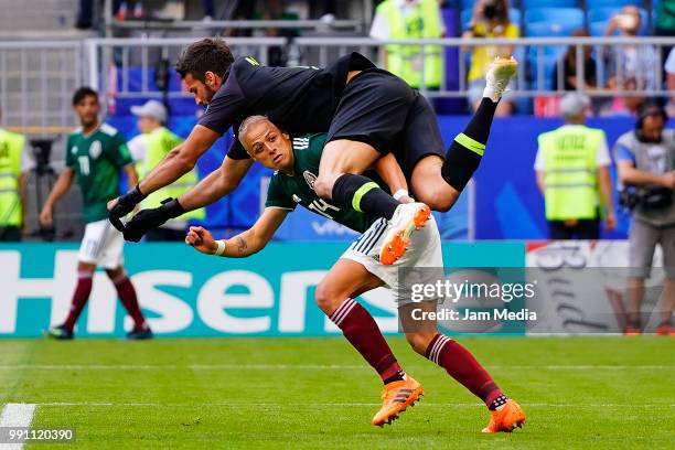 Javier Hernandez of Mexico fights for the ball with Alisson of Brazil during the 2018 FIFA World Cup Russia Round of 16 match between Brazil and...