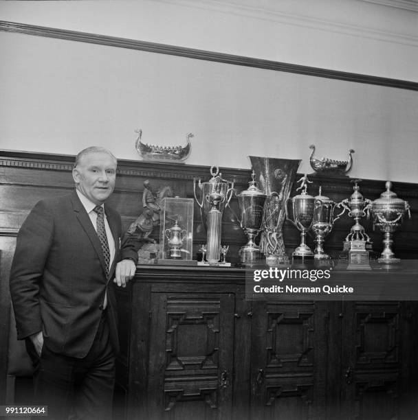 English former football player Bill Nicholson , manager of Tottenham Hotspur FC, with Spurs' trophies and awards, London, UK, 3rd March 1973.