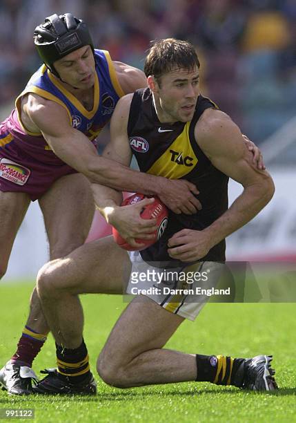 Jason Torney of Richmond is tackled by Shaun Hart of Brisbane during the Round 19 AFL match at the Gabba in Brisbane, Australia. DIGITAL IMAGE....