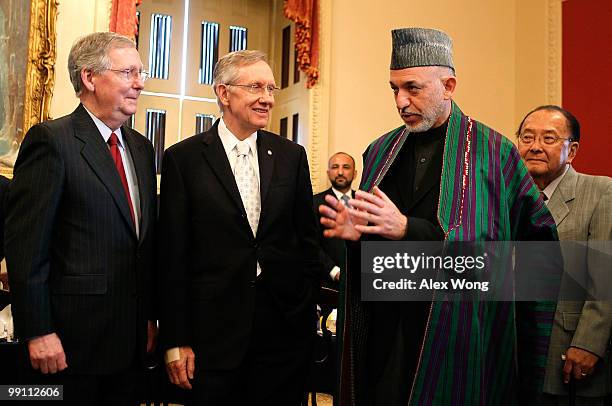 Afghan President Hamid Karzai speaks as U.S. Senate Minority Leader Sen. Mitch McConnell , Senate Majority Leader Sen. Harry Reid , and Sen. Daniel...