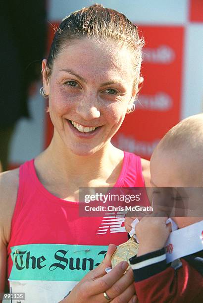 City to Surf womans winner Susie Power holds her son Jai after winning the 2001 Sun Herald City to Surf marathon at Bondi Beach in Sydney, Australia....