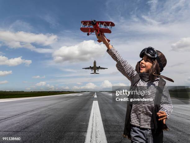 boy playing with toy airplane on runway - small airplane stock pictures, royalty-free photos & images
