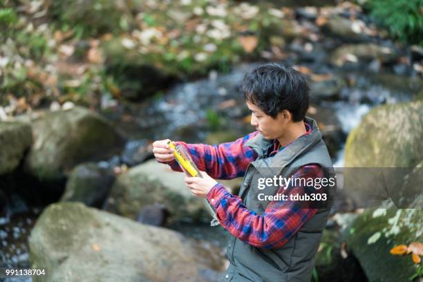a scientist monitoring water quality from a field laboratory - pollution officer stock pictures, royalty-free photos & images