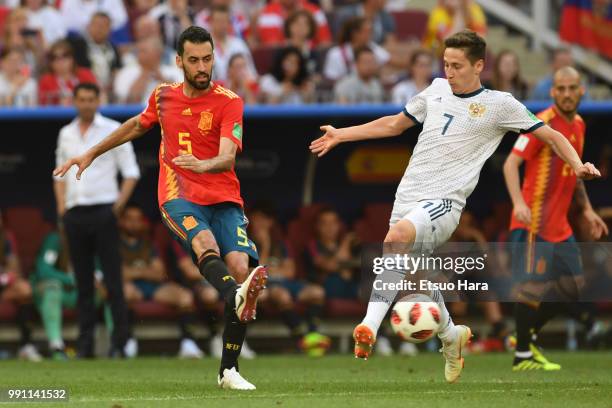 Sergio Busquets of Spain and Daler Kuziaev of Russia compete for the ball during the 2018 FIFA World Cup Russia Round of 16 match between Spain and...