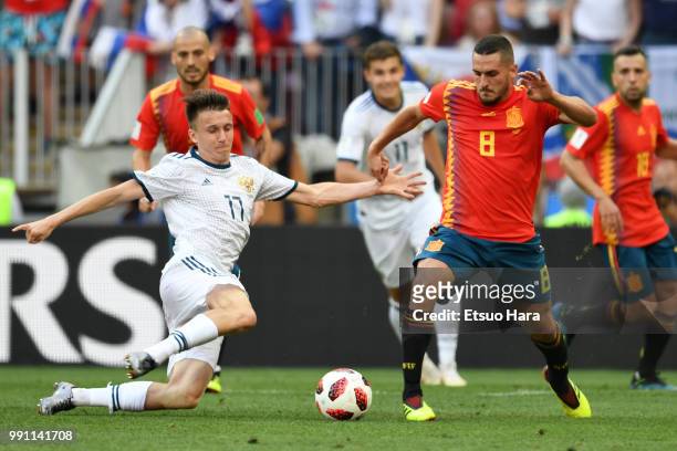 Aleksandr Golovin of Russia and Koke of Spain compete for the ball during the 2018 FIFA World Cup Russia Round of 16 match between Spain and Russia...