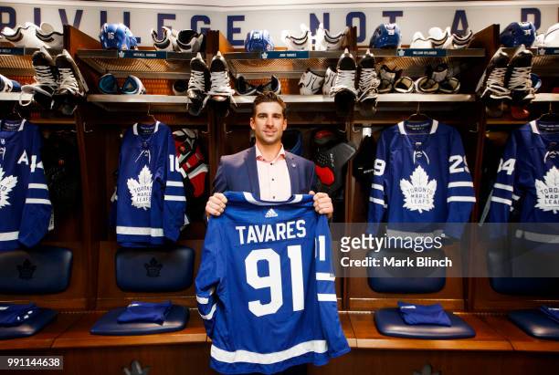 John Tavares of the Toronto Maple Leafs, poses with his jersey in the dressing room, after he signed with the Toronto Maple Leafs, at the Scotiabank...
