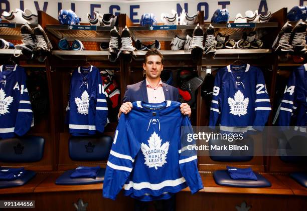 John Tavares of the Toronto Maple Leafs, poses with his jersey in the dressing room, after he signed with the Toronto Maple Leafs, at the Scotiabank...