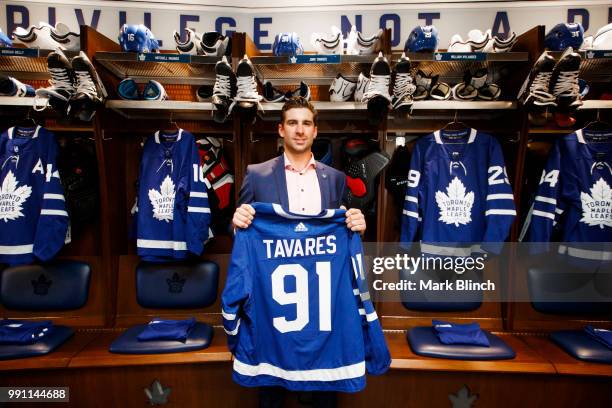 John Tavares of the Toronto Maple Leafs, poses with his jersey in the dressing room, after he signed with the Toronto Maple Leafs, at the Scotiabank...