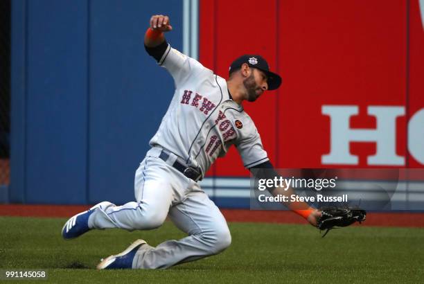 New York Mets right fielder Jose Bautista makes a catch off a Russell Martin hit to record the third out of the first inning as the Toronto Blue Jays...