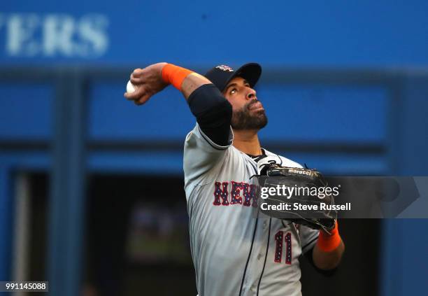 New York Mets right fielder Jose Bautista throws the ball to fans after making a catch off a Russell Martin hit to record the third out of the first...