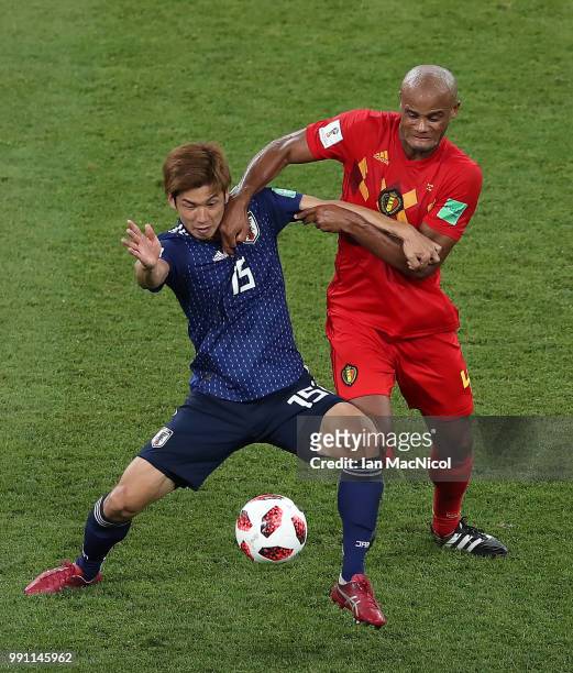 Yuya Osako of Japan vies with Vincent Kompany of Belgium during the 2018 FIFA World Cup Russia Round of 16 match between Belgium and Japan at Rostov...