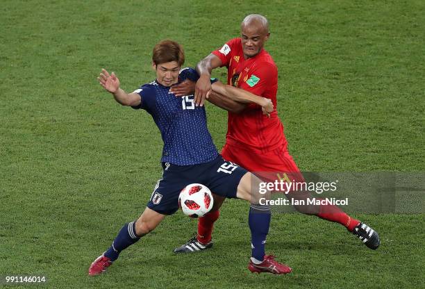 Yuya Osako of Japan vies with Vincent Kompany of Belgium during the 2018 FIFA World Cup Russia Round of 16 match between Belgium and Japan at Rostov...