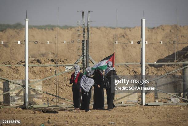 Women are seen standing next to a wire fence. Clashes between Palestinian citizens and the Zionist occupation forces during the protest against the...