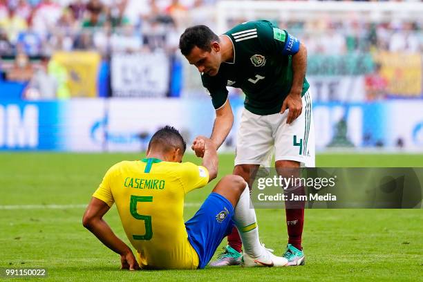 Rafael Marquez of Mexico helps Casemiro of Brazil during the 2018 FIFA World Cup Russia Round of 16 match between Brazil and Mexico at Samara Arena...