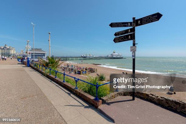 a view of the beach, promenade and pier, eastbourne - eastbourne pier photos et images de collection