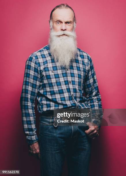 full length portrait of confident senior man standing against pink background - plaid shirt isolated stock pictures, royalty-free photos & images