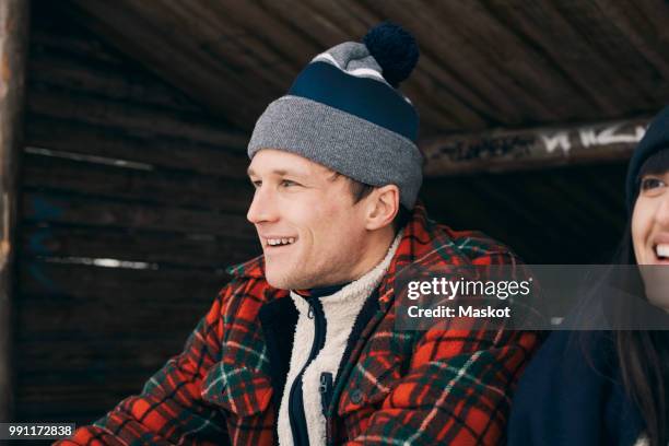 close-up of smiling man and woman sitting in log cabin - swedish log cabin bildbanksfoton och bilder