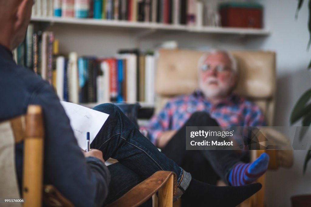 Male therapist with senior patient during therapy session