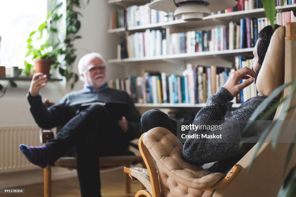 Therapist explaining male patient during session at home office