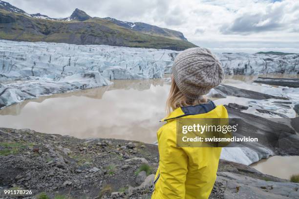 young woman contemplating glacier lake in iceland - south east iceland stock pictures, royalty-free photos & images