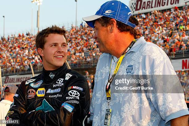Trevor Bayne, driver of the Diamond Waltrip Racing Toyota, talks with team owner Michael Waltrip on the grid prior to the start of the NASCAR...
