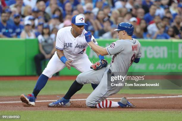 Brandon Nimmo of the New York Mets is tagged out attempting to steal third base by Yangervis Solarte of the Toronto Blue Jays in the fifth inning...