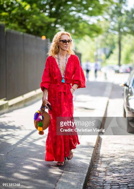 Elina Halimi wearing red dress, Celine bag is seen outside Ulyana Sergeenko on day three during Paris Fashion Week Haute Couture FW18 on July 2, 2018...