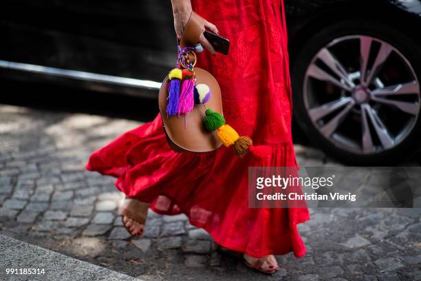 Elina Halimi wearing red dress, Celine bag is seen outside Ulyana Sergeenko on day three during Paris Fashion Week Haute Couture FW18 on July 2, 2018...