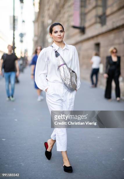Doina Ciobanu wearing silver Isabel Marant belt bag, white pants and top is seen outside Alexandre Vauthier on day three during Paris Fashion Week...