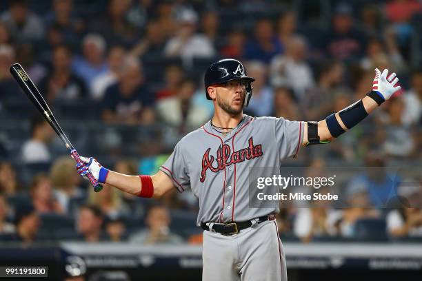 Tyler Flowers of the Atlanta Braves reacts after being called out on strikes in the fourth inning against the New York Yankees at Yankee Stadium on...