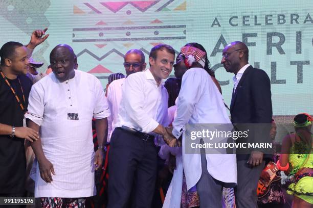 French President Emmanuel Macron stands next to Lagos Governor Akinwunmi Ambode at the Afrika Shrine in Lagos on July 3, 2018. - French President...