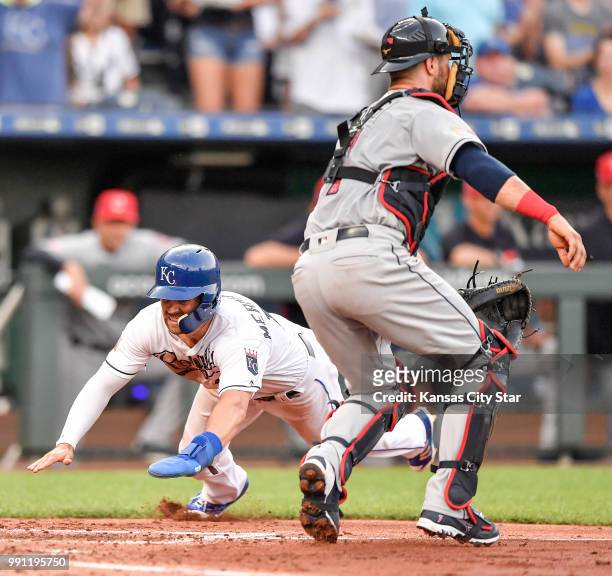 The Kansas City Royals' Whit Merrifield scores around Cleveland Indians catcher Yan Gomes on a double by Rosell Herrera in the second inning on...
