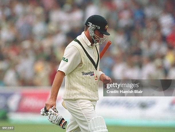 Mark Waugh of Australia walks off after being caught by Alec Stewart of England off the bowling of Andrew Caddick during the second day of the...