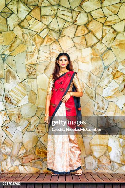 beautiful indian female in colorful sari full length portrait in front of marble wall - gold sari imagens e fotografias de stock