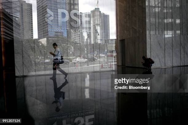 Man walks below signage for Philippine Stock Exchange Inc. Displayed in the lobby of the bourse in Bonifacio Global City , Metro Manila, the...