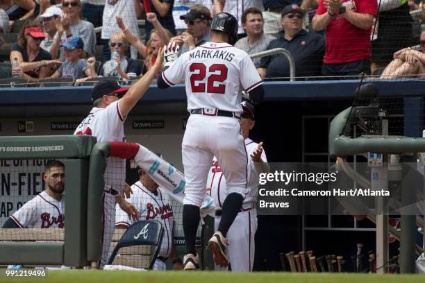 Nick Markakis of the Atlanta Braves celebrates after scoring against the Cincinnati Reds at SunTrust Park on June 27 in Atlanta, Georgia. The Reds...