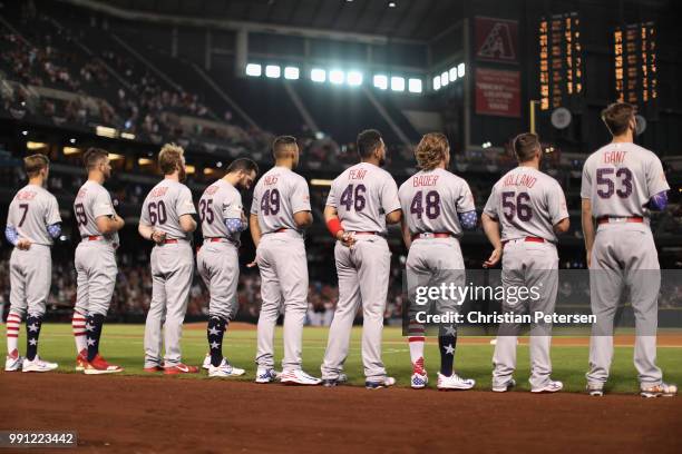 The St. Louis Cardinals stand attended for the national anthem before the MLB game against the Arizona Diamondbacks at Chase Field on July 3, 2018 in...