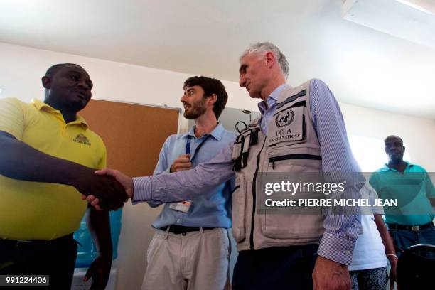 Deputy Secretary of the United Nations Office for the Coordination of Humanitarian Affairs Mark Lowcock , next to Olivier Tenes , an International...