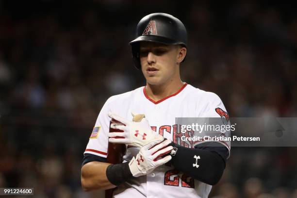 Jake Lamb of the Arizona Diamondbacks adjusts his batting gloves during the first inning of the MLB game against the St. Louis Cardinals at Chase...