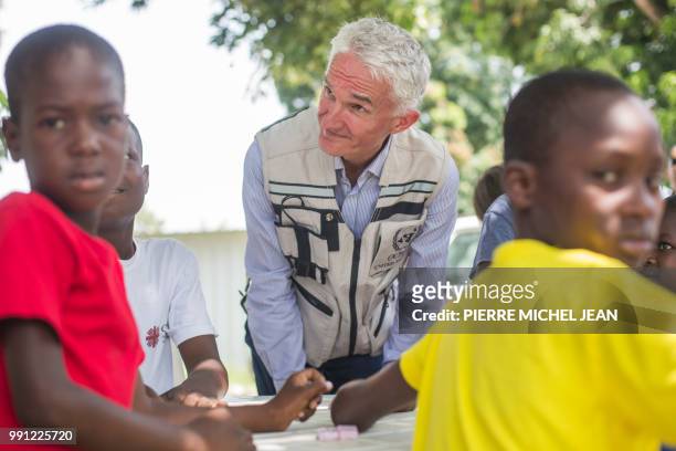 Deputy Secretary of the United Nations Office for the Coordination of Humanitarian Affairs Mark Lowcock visits with children at 'la maison daccueil...
