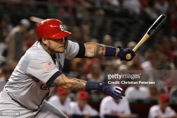 Yadier Molina of the St. Louis Cardinals hits a single against the Arizona Diamondbacks during the second inning of the MLB game at Chase Field on...