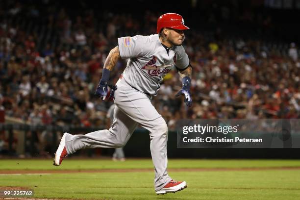 Yadier Molina of the St. Louis Cardinals runs to first base after hitting a single against the Arizona Diamondbacks during the second inning of the...