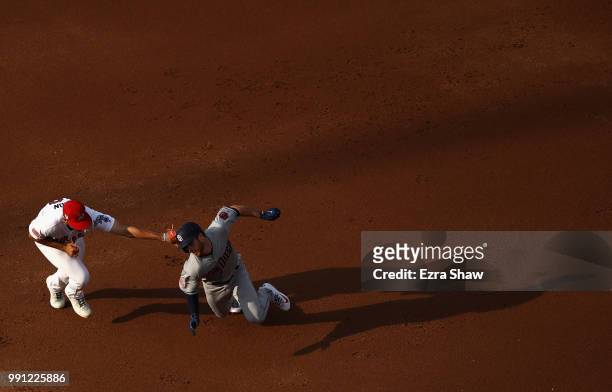 Matt Olson of the Oakland Athletics tags out Cory Spangenberg of the San Diego Padres to complete a double play in the second inning at Oakland...