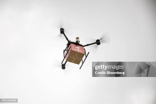 Com Inc. Drone flies during a package delivery deomstration at the company's drone testing site in Xi'an, China, on Tuesday, June 19, 2018. JD.com is...