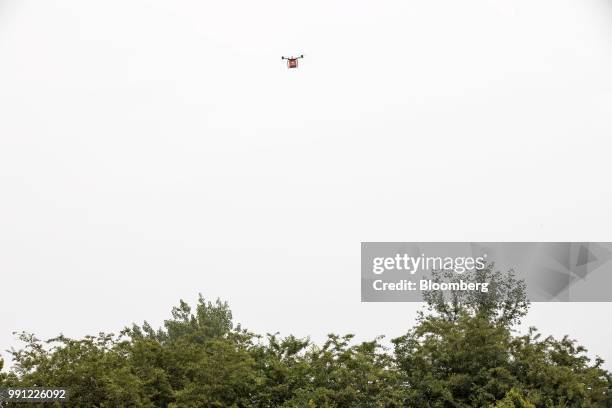 Com Inc. Drone flies during a package delivery demonstration at the company's drone testing site in Xi'an, China, on Tuesday, June 19, 2018. JD.com...