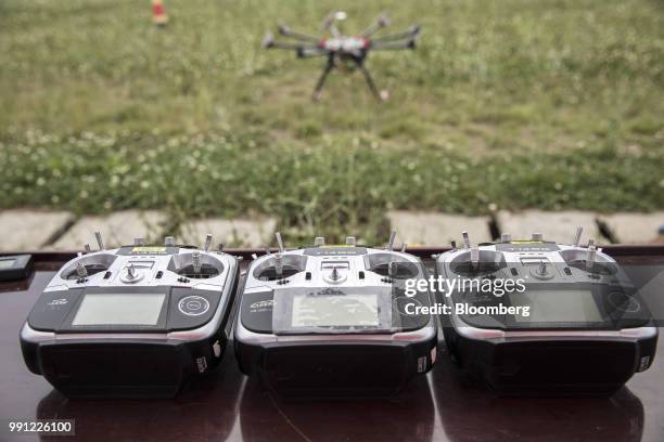 Drone controllers sit on a table during a JD.com Inc. Package delivery training session at the company's drone testing site in Xi'an, China, on...