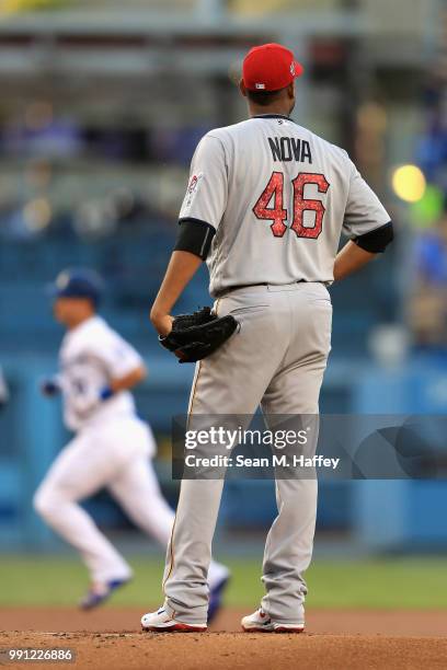 Ivan Nova of the Pittsburgh Pirates looks on as Joc Pederson of the Los Angeles Dodgers rounds second base after hitting a solo homerun during the...